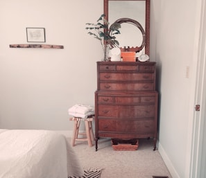 Master Bedroom dresser with sound machine,  essential oils, robes and slippers 