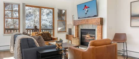 Cozy Up in this Updated Living Room with Gas Fireplace & Access to the Private Deck!