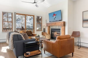 Cozy Up in this Updated Living Room with Gas Fireplace & Access to the Private Deck!