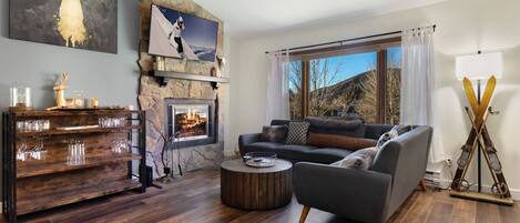 Living Room with Wood Burning Fireplace and Large Screen TV