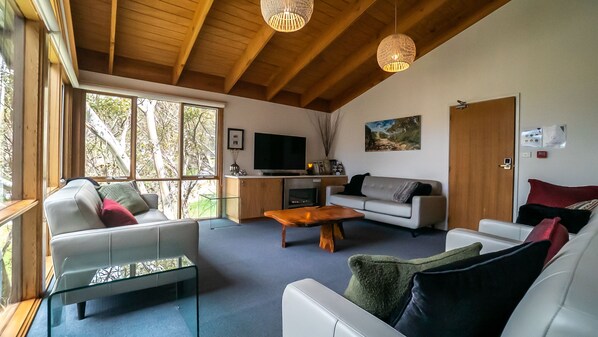 Lounge room - cathedral ceilings with a gas log fireplace and 4 leather couches 