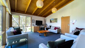 Lounge room - cathedral ceilings with a gas log fireplace and 4 leather couches 