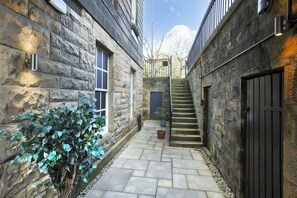 Entrance and stairs down to the apartment's private main door. 
. 