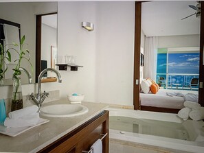 The wall behind the Jacuzzi tub opens into the bedroom to enjoy an outside vista