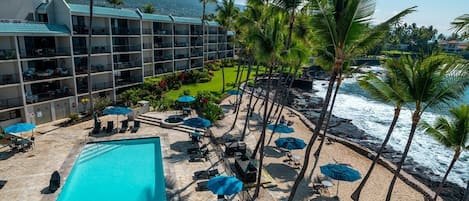 Beautiful view from your living room and lanai of the Pacific, inviting pool area and your private sandy beach :)