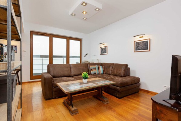 Relax in the stylish living room with a comfortable sofa and cosy decor.