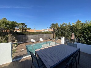 View of the pool from the terrace with outdoor lounge