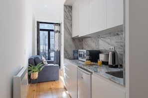 The kitchen is equipped with glasses, cups, plates, cutlery and a lots of equipments!