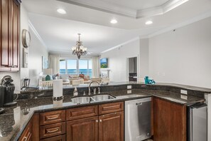 Kitchen with stand alone ice maker - Your Friend at the Beach full stocks each of our Adagio condos with everything you need for the perfect beach vacation. There is a regular coffee maker plus a Keurig in each of our condos- and plenty of bakeware, serving items, and pots/pans. YFAB even includes a crockpot and a robust mixer for those fruity, fun drinks.