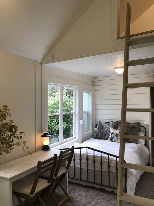 The double bed and ladder up to the sleeping loft nook w/a twin foam pad. 