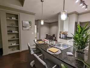 View from the living into the kitchen and dining w/extra seating at bar