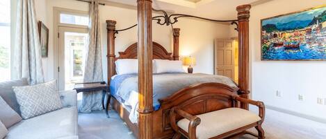The en-suite bedroom on the main floor has a King bed, access to the deck and a double-sided full bath.