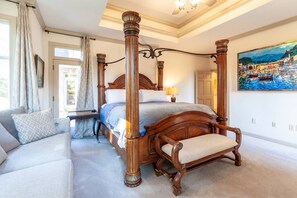 The en-suite bedroom on the main floor has a King bed, access to the deck and a double-sided full bath.