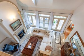 The 2-story family room has access to the back deck with water views through the French doors.