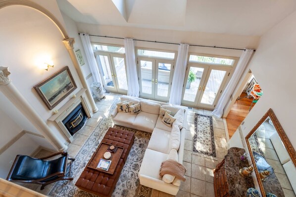 The 2-story family room has access to the back deck with water views through the French doors.