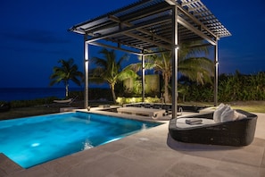 Full swim up bar and outdoor kitchen with grill beside the heated pool.