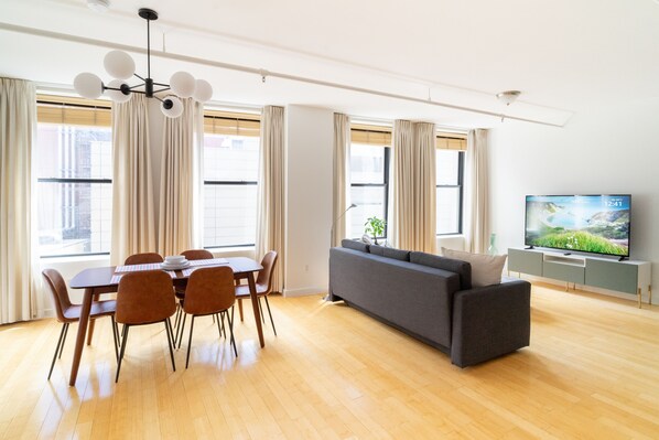 Living and dining room with a 65" smart TV