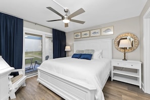 Primary Bedroom with Patio Access – You'll love stepping out into the coastal air from the privacy of the bedroom.