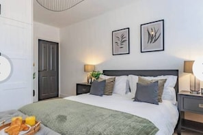 Gorgeous main bedroom complete with king-sized bed, dressing area and fitted wardrobes (1)
