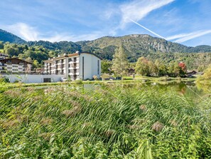 Sky, Cloud, Plant, Building, Mountain, Natural Landscape, Land Lot, Flower, House, Bank