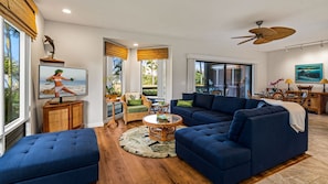 A large TV and a comfortable, large sectional couch