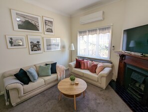 Gorgeous light, high ceilings and a feature fireplace in the comfy lounge room