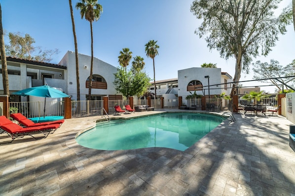Remodeled Pool with designer travertine and newer furniture