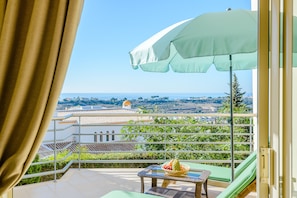 The lovely ocean view terrace with 2 chairs and a table.