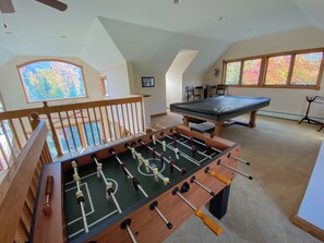 Loft Entertainment Space: Kick back on the sectional couch, watch your favorite shows on the TV, or challenge your group to a game of foosball or pool.