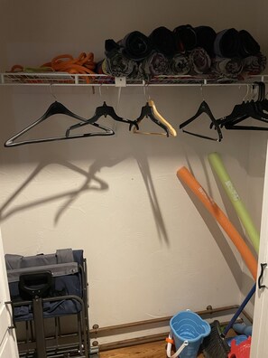 Closet by front door with beach utility wagon, beach sand toys, beach towels