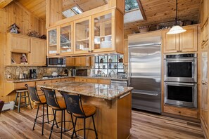 Kitchen offers and island and double ovens for cooking connivence