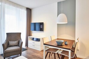 Wohn/Essbereich mit Sessel, Esstisch und TV