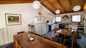 Dining Room with kitchen in background with 2 large fridges