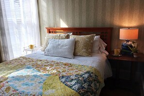 Luxurious queen bed with fireplace & garden views