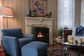 Living area has romantic gas log fireplace