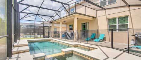 Screened backyard with heated pool and spa, BBQ, dinning table and lounge chairs