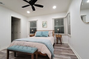 The master bedroom is furnished with a spacious and comfortable king-sized bed, along with a Smart TV for entertainment. Additionally, it includes a private bathroom for the guests' convenience.