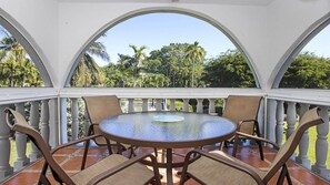 Private, second-level screened patio with view of nicely landscaped garden area.
