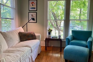 Sitting area with treetop view & queen sofa bed