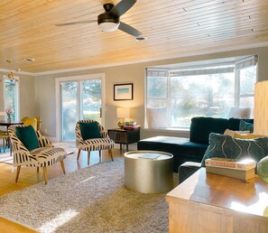 Sunny living room with sectional, comfy chairs, smart TV and great views