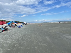 The beach at low tide adjoining Monarch. A beach club fronts on the beach.