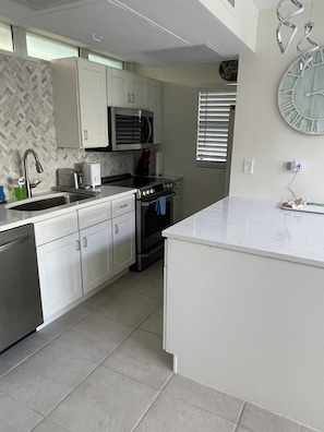 Full service kitchen with new appliances.