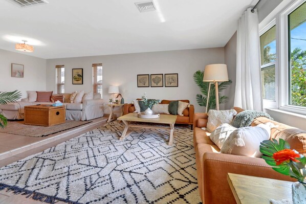 A beautiful & spacious sunken living room with a Roku TV is ideal for larger gatherings