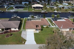 A vacation home designed for family enjoyment - spacious fenced yard, pool, Gulf-access waterfront - many memories to be made!