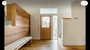 Front entrance with redwood wall & hand-hewn coat hooks.