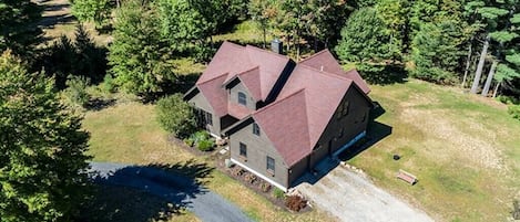 Birds eye view of the home boasting over 4000 Sq Ft of living space for guests to use with sleeping arrangements for up to 16 guests. Take a short walk to the back of the home and enjoy 460 ft on the Potash Brook. Minutes away from Whiteface mountain