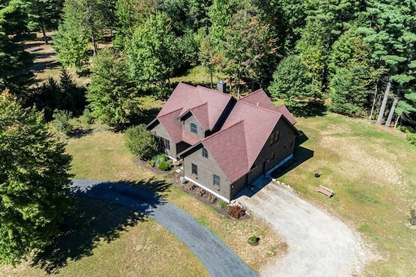 Birds eye view of the home boasting over 4000 Sq Ft of living space for guests to use with sleeping arrangements for up to 16 guests. Take a short walk to the back of the home and enjoy 460 ft on the Potash Brook. Minutes away from Whiteface mountain