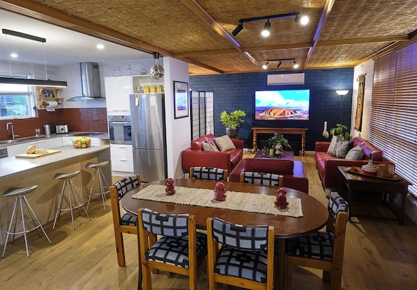 The living area is open to the kitchen and looks out over the front garden