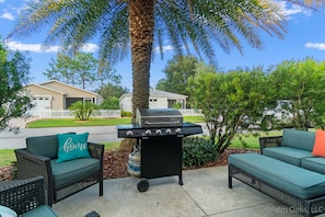 Outside sitting area with gas grill.