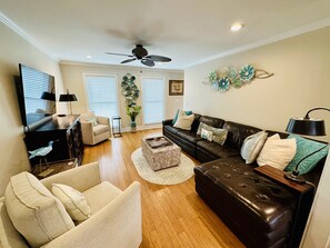 Living Room with leather couch for 6.  Comfortable swivel chairs and large TV 